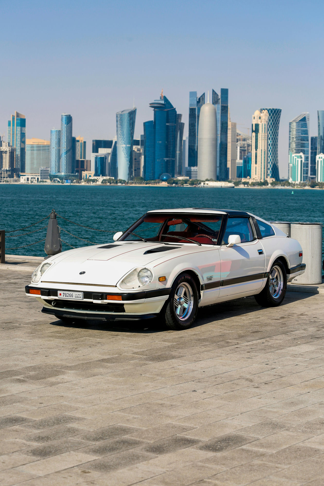 Classic car with Doha skyline